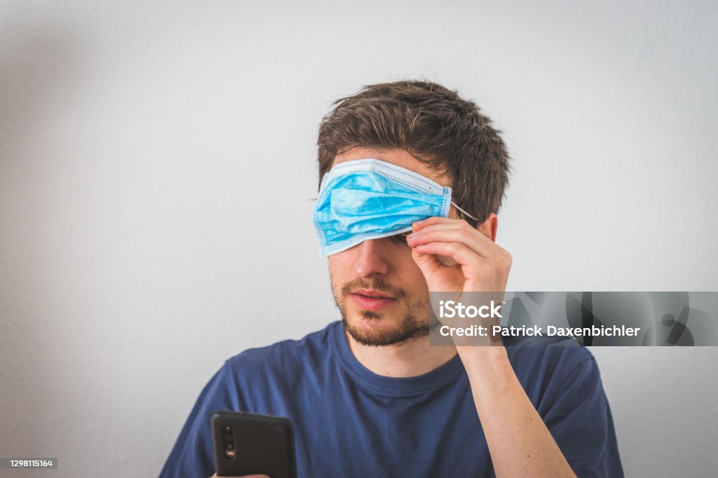 Conspiracy theory concept: Young man with face mask over the eyes Young man with face mask over the eyes. Conspiracy theory concept. Conspiracy Theory Stock Photo