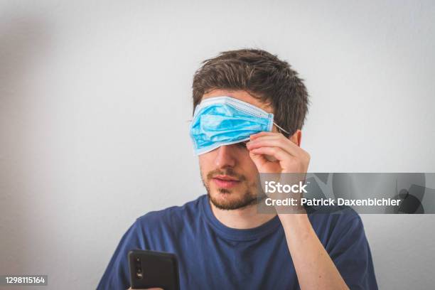 Conspiracy Theory Concept Young Man With Face Mask Over The Eyes Stock Photo - Download Image Now