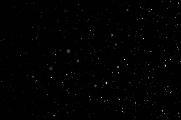 istock Real snow isolated on pure black background 1298117639