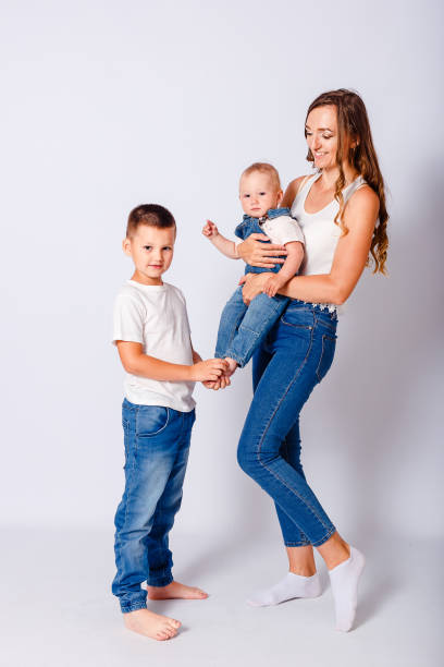 Happy mother and two children on a white background