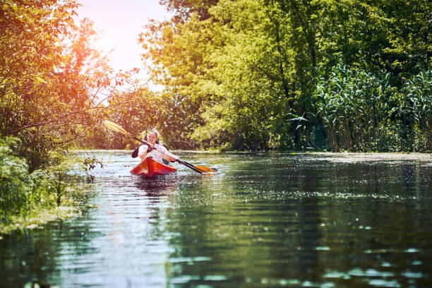 istock Happy best friends having fun on a kayaks. Kayaking on the river. 1298123920