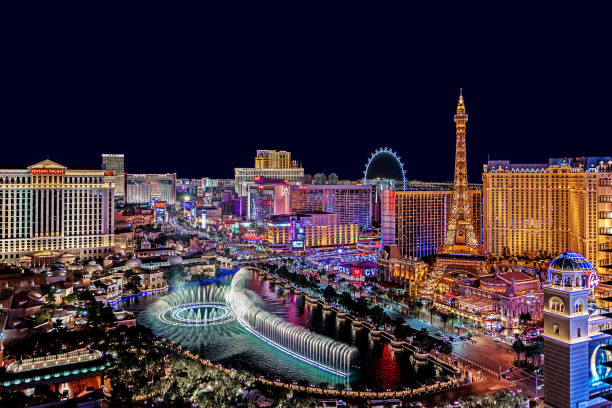 The famous Las Vegas Strip with the Bellagio Fountain. The Strip is home to the largest hotels and casinos in the world. Las Vegas, USA - February 17, 2018 Panoramic view of Las Vegas strip at night in Nevada. the strip las vegas stock pictures, royalty-free photos & images