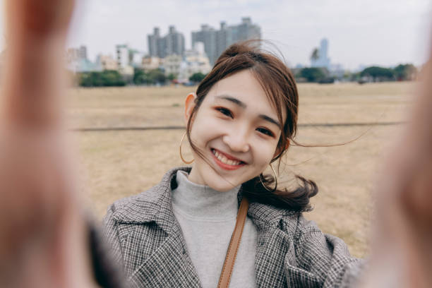 istock Asian woman smile take selfie 1298124676