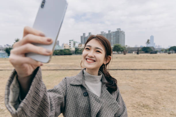 istock Asian woman smile take selfie 1298124712