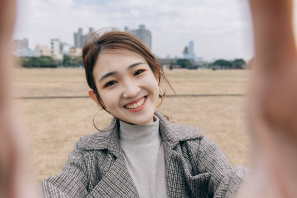 istock Asian woman smile take selfie 1298124743