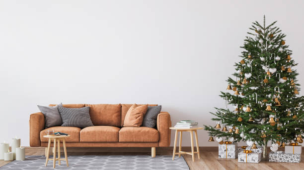 living room christmas interior in scandinavian style. christmas tree with gift boxes. orange sofa on wall mockup - fake rattan imagens e fotografias de stock