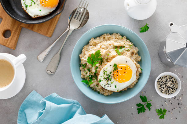 istock Savoury oatmeal with fried eggs sunny side up for breakfast 1298128696