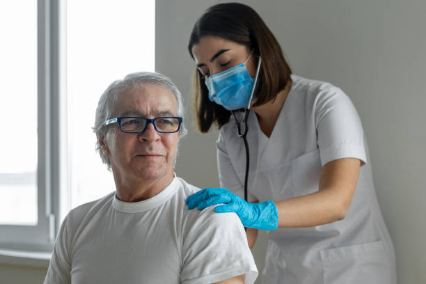 istock Doctor using stethoscope listening to senior patients breathing 1298128826