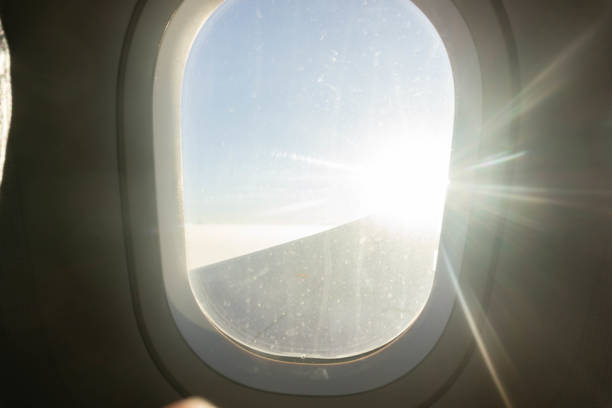 istock Airplane window with white light, travel by plane. 1298129795