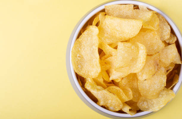 istock Potato chips in the gray bowl on yellow 1298130637
