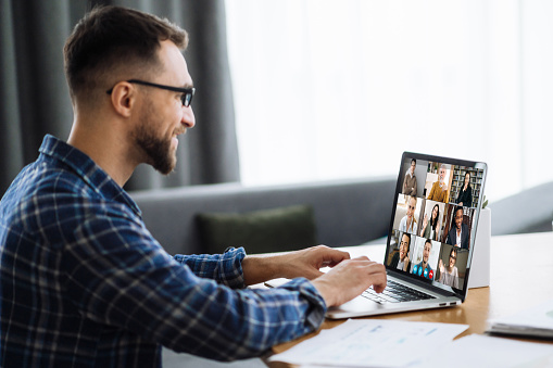 Video call, online business meeting, online education. Successful caucasian freelancer or student communicate with   business colleagues or studying online via video conference