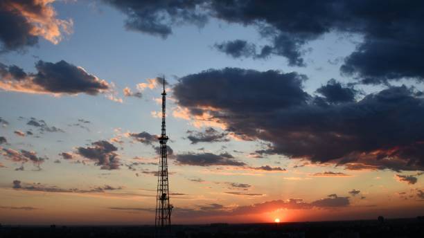 istock Blur silhouette of communication tower with sunset cloudscape skyline 1298134536