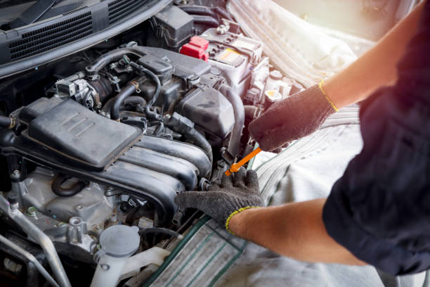 istock Auto mechanic hand working with engine in garage, car service technician repairing customer car at automobile service center, inspecting car suspension and engine system, vehicle repair service shop. 1298135036