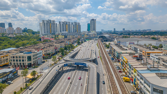 Selangor skyline in Malaysia with two U-turn highway in the downtown city. Business parkland, railway station, and residential building.