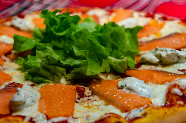 istock Pizza with salmon, herbs and cheese 1298135318