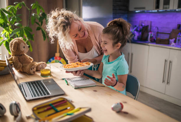 little child girl with grandmother using laptop at home - eating senior adult color image spaghetti imagens e fotografias de stock