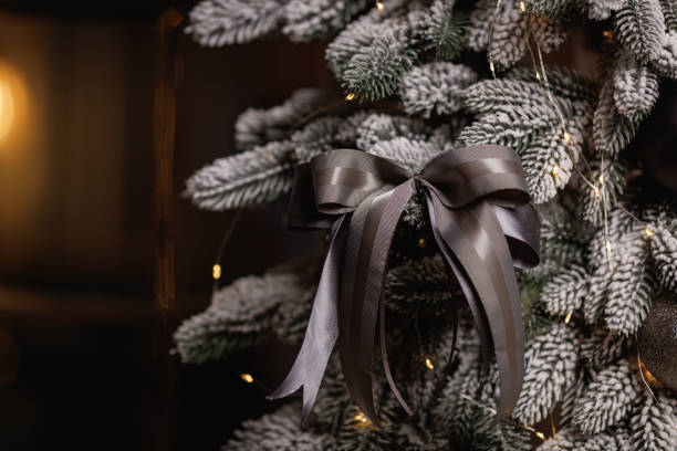 istock Christmas tree with silver bow decoration and balls 1298136261