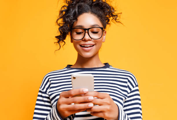 istock Young ethnic woman using smartphone 1298137791