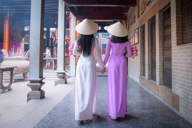 Vietnam woman wearing Ao Dai culture traditional at old temple. Young Vietnam woman wearing Ao Dai culture traditional at old temple at Ho Chi Minh in Vietnam,vintage style,travel and relaxing concept. ao dai stock pictures, royalty-free photos & images