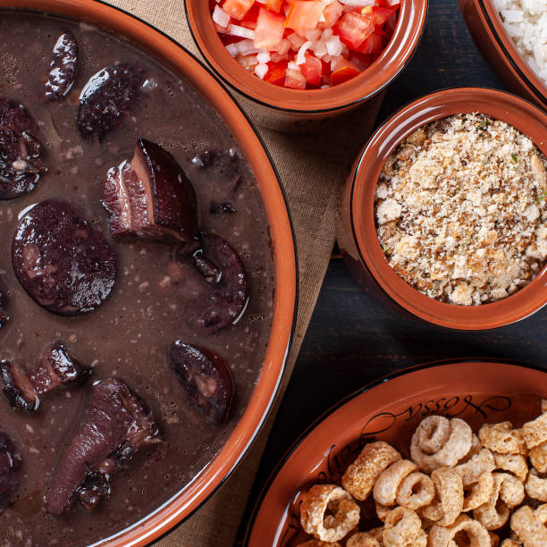 istock Typical Brazilian dish called Feijoada. Made with black beans, pork and sausage. Top view 1298140569