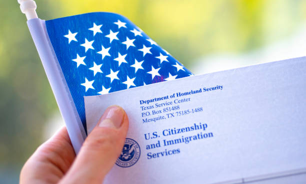 The Letter (Envelope) from USCIS covered in flags of USA. Close up view. stock photo