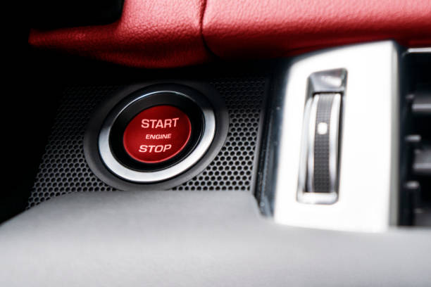 istock Car dashboard with focus on red engine start stop button. Modern car interior details. start/stop button. Car inside. Ignition remote starter 1298145127