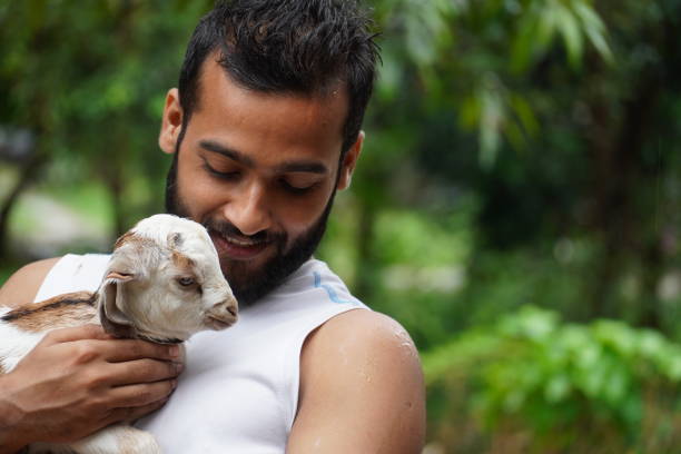 istock A man stands with the goat in his hand 1298145175