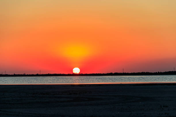 istock Beautiful orange sunset over a salt lake 1298147144