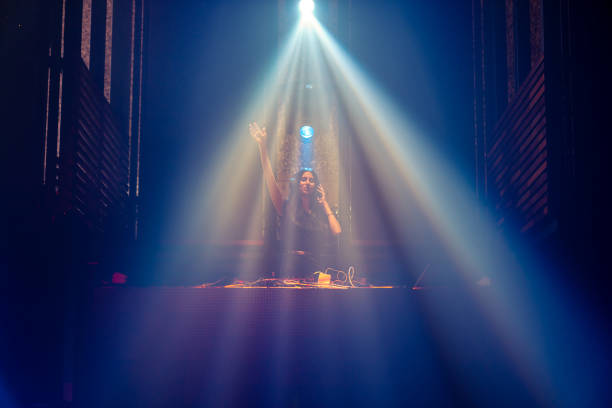 istock DJ on stage in disco night club mixing techno music beat 1298147553