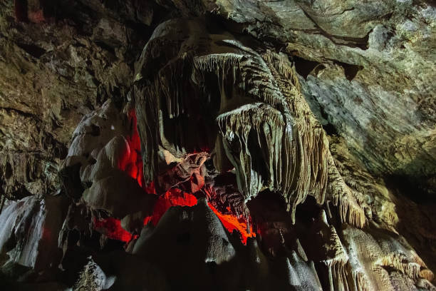 istock It is an underground cave with stalactites and stalagmites and a glowing crater. 1298149772