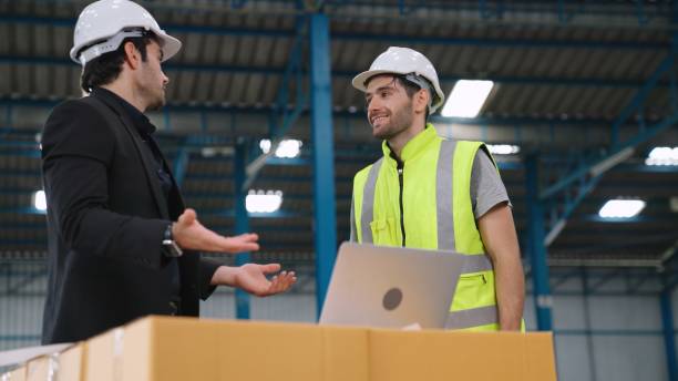 istock Two factory workers working and discussing manufacturing plan in the factory . 1298149826