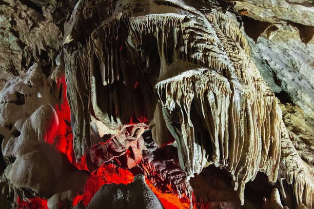 istock It is an underground cave with stalactites and stalagmites and a glowing crater. 1298149893
