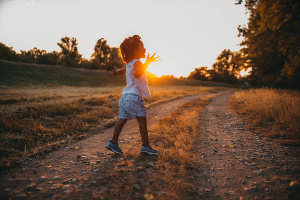 istock Boy playing with airplane toy in field 1298151140
