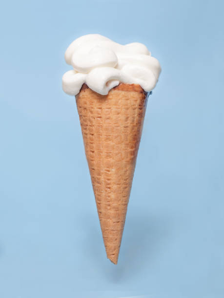 istock vanilla white ice cream cone isolated on blue background 1298151450