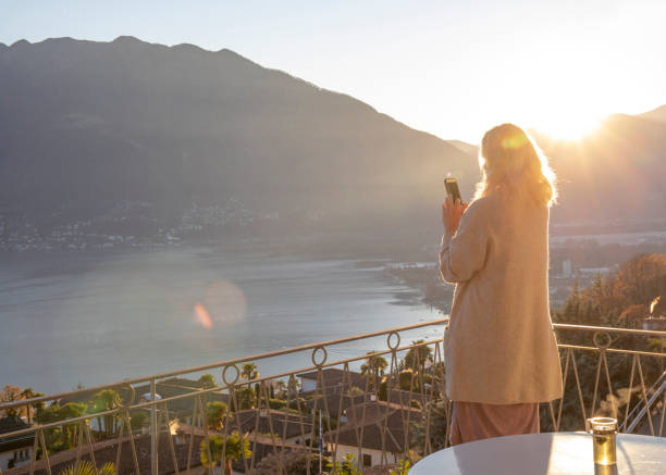istock Woman relaxes on balcony at sunrise 1298152637