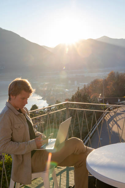 istock Young man works from home on balcony in the morning 1298152822