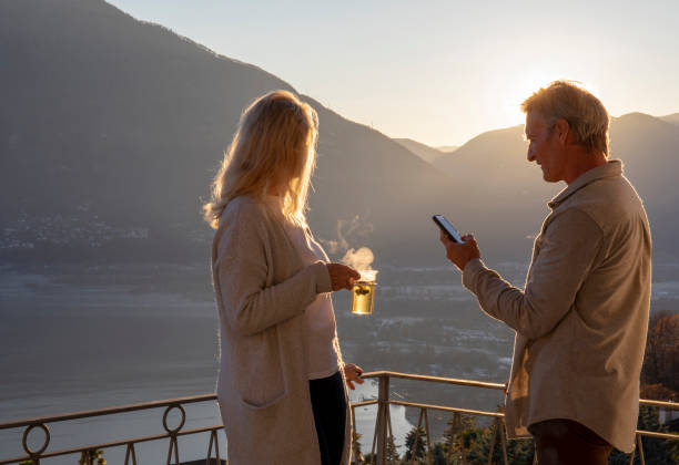 istock Mature couple relaxes on balcony at sunrise 1298152998