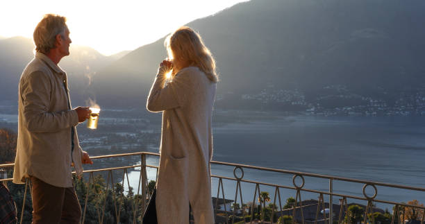 istock Mature couple relaxes on balcony at sunrise 1298153215