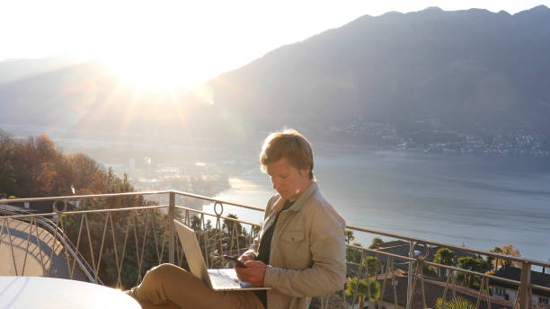 istock Young man works from home on balcony in the morning 1298153244