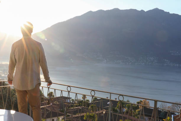 istock Young man relaxes on balcony in the morning 1298153291