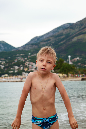 little blond boy came out of the sea to the shore, was cold and really creepy