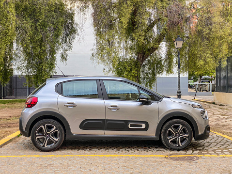 Valencia, Spain - January 21, 2021: Silver colored Citroen car model C3 parked in the street. The French manufacturer produces this car since 2002