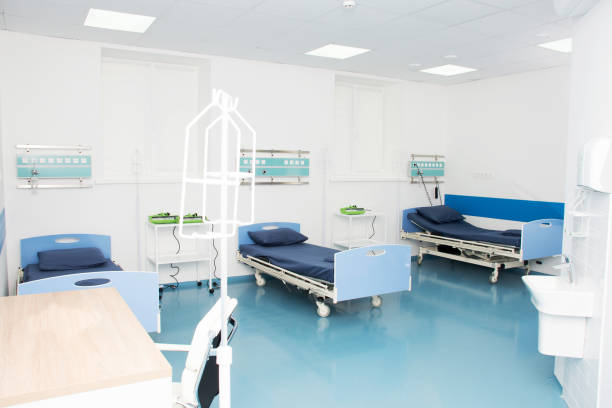 istock Empty modern hospital room for several patients. 1298156670