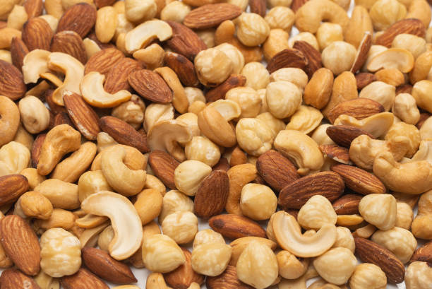 istock Mix of nuts isolated on white background. Top view. 1298158585