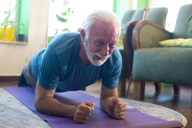 istock Senior man exercising at home 1298159338