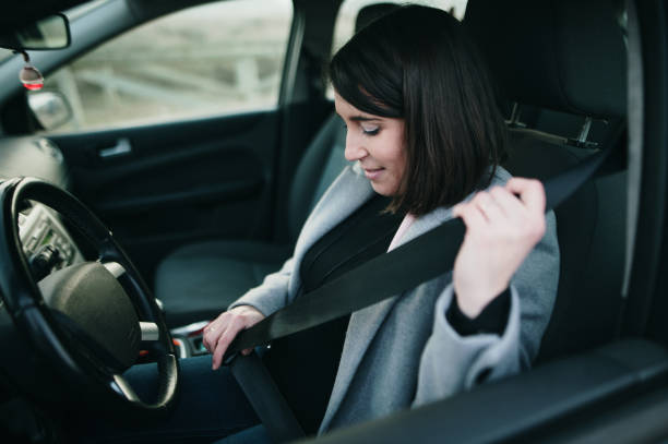 istock Driver woman fastening her seat belt 1298159449
