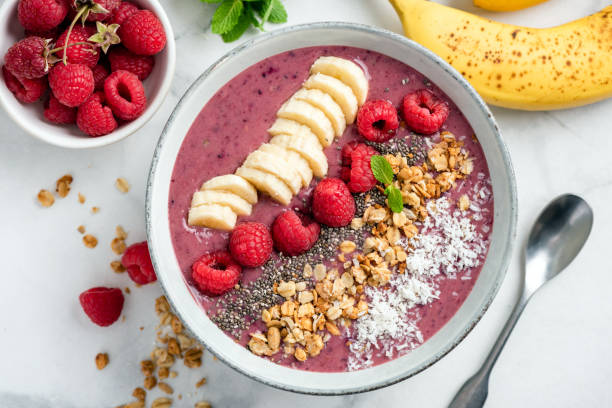 Acai Smoothie Bowl With Toppings Vegan Acai Smoothie Bowl With Toppings Banana Raspberry Granola Coconut. Top view smoothie stock pictures, royalty-free photos & images