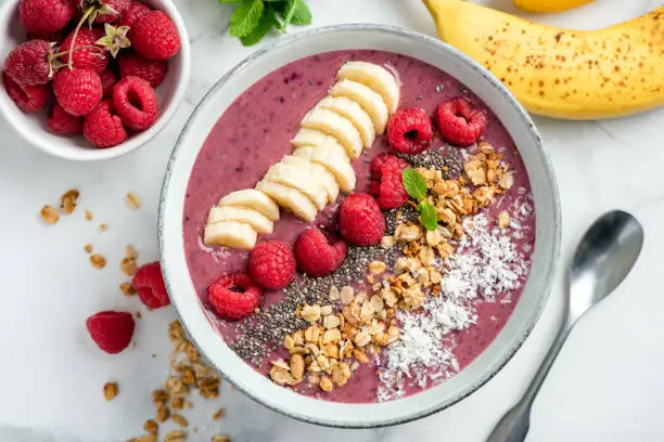 Vegan Acai Smoothie Bowl With Toppings Banana Raspberry Granola Coconut. Top view