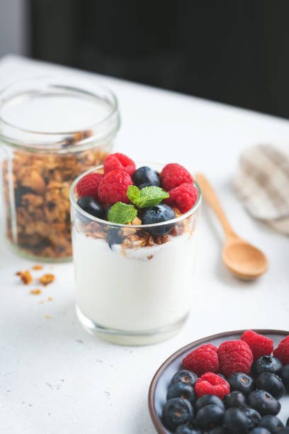 istock Yogurt with granola and berries in jar 1298159908
