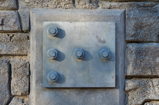 Close-up of nuts and bolts in a bridge abutment, to illustrate the concept of infrastructure